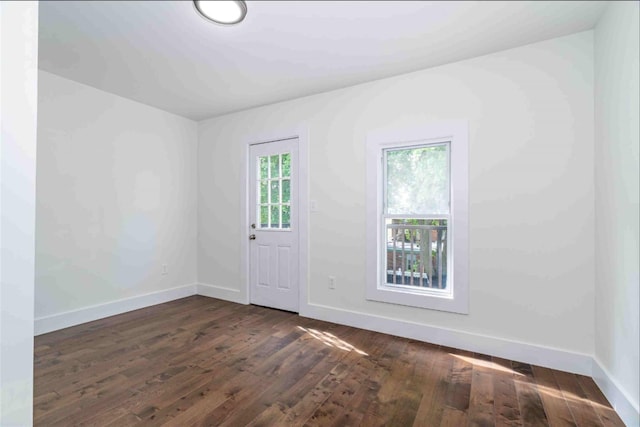 spare room with dark hardwood / wood-style floors