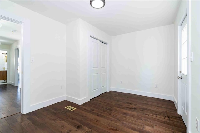 unfurnished room featuring dark wood-type flooring