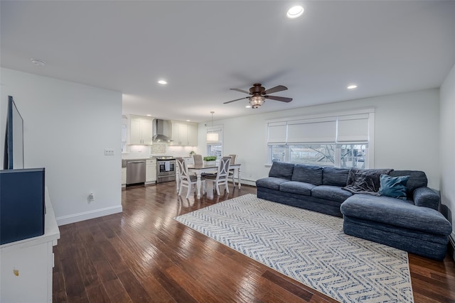 living room with ceiling fan and dark wood-type flooring