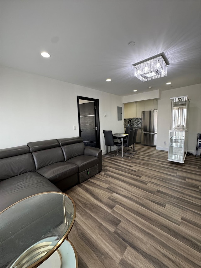 living room featuring electric panel and dark wood-type flooring