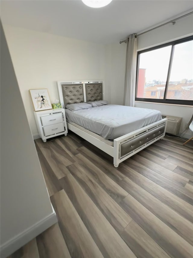 bedroom with dark wood-type flooring