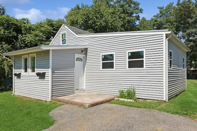 view of front of house with a patio area and a front yard