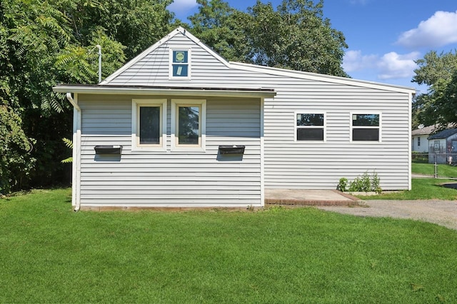 view of property exterior featuring a lawn