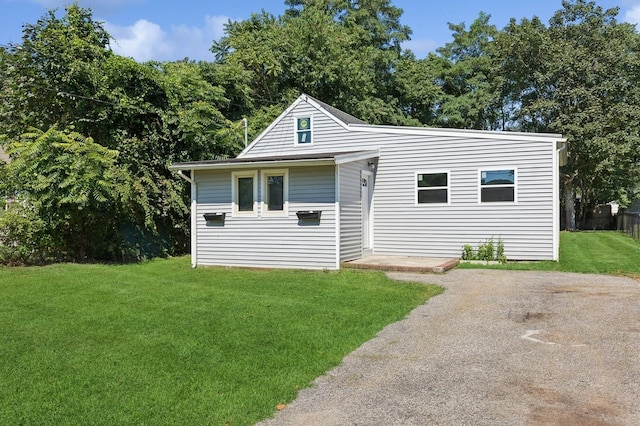 view of side of home featuring a lawn