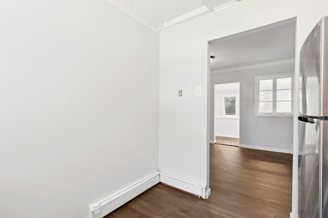 unfurnished room with dark hardwood / wood-style flooring, ornamental molding, and baseboard heating