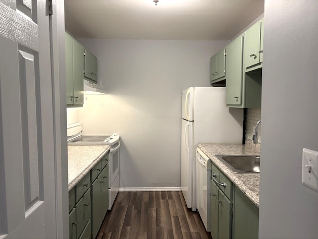 kitchen featuring sink, tasteful backsplash, dark hardwood / wood-style flooring, white appliances, and green cabinetry