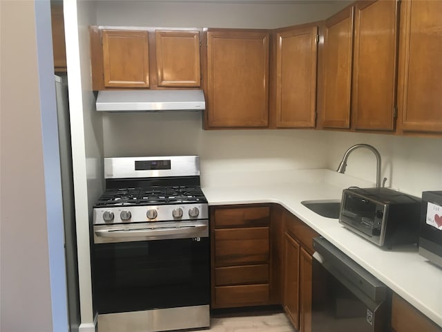 kitchen featuring sink, dishwasher, and stainless steel gas range oven