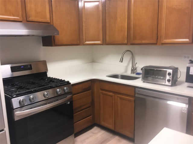 kitchen featuring light hardwood / wood-style floors, sink, and appliances with stainless steel finishes