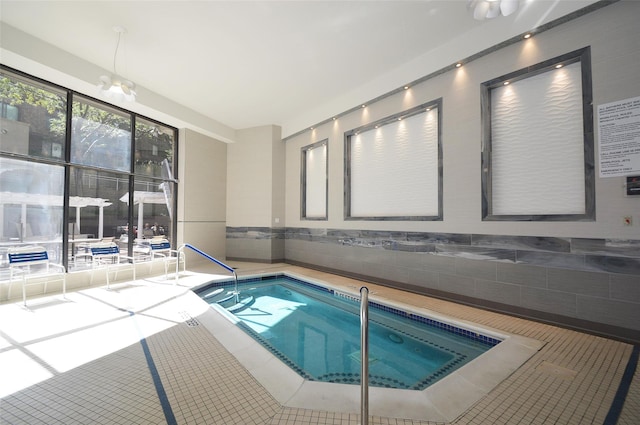 view of swimming pool featuring an indoor hot tub