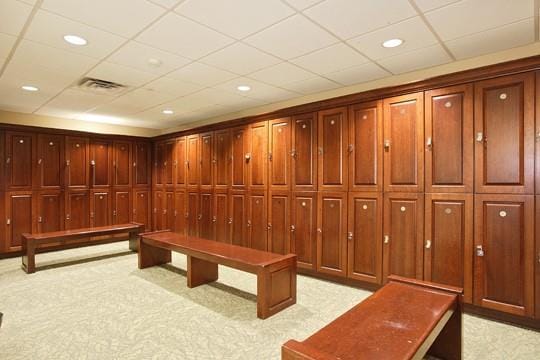 interior space with light carpet and a paneled ceiling