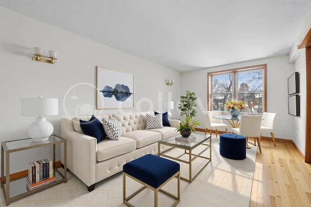 living room featuring light wood finished floors and baseboards