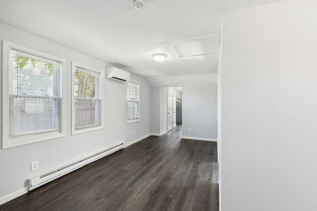 spare room featuring dark hardwood / wood-style floors, an AC wall unit, baseboard heating, and vaulted ceiling