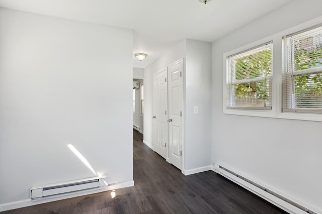 hall featuring dark hardwood / wood-style flooring and a baseboard heating unit