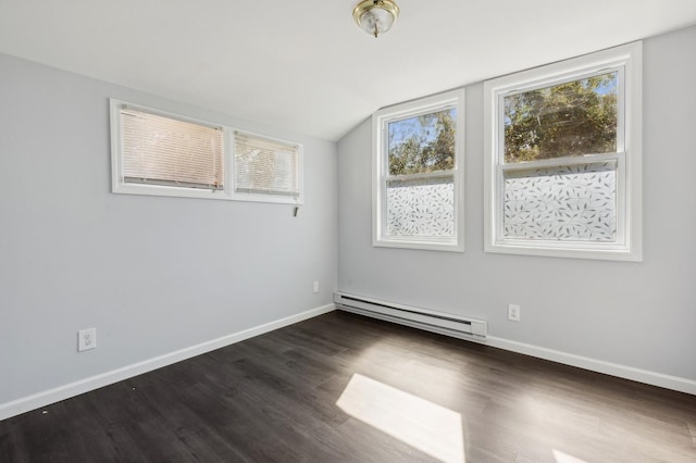 spare room with a baseboard radiator, vaulted ceiling, and dark wood-type flooring