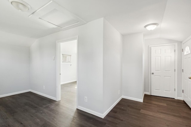 interior space featuring dark hardwood / wood-style flooring and lofted ceiling