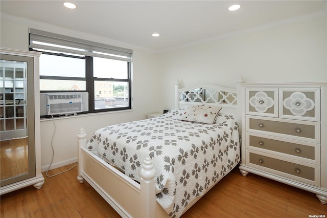 bedroom featuring hardwood / wood-style flooring and ornamental molding