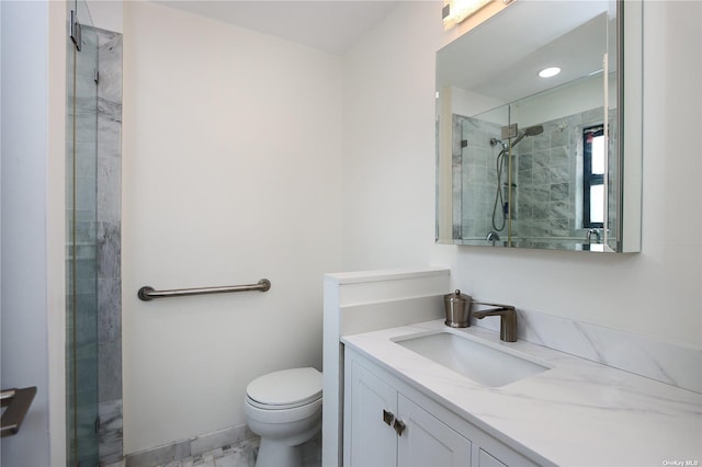 bathroom featuring vanity, toilet, and a shower with shower door