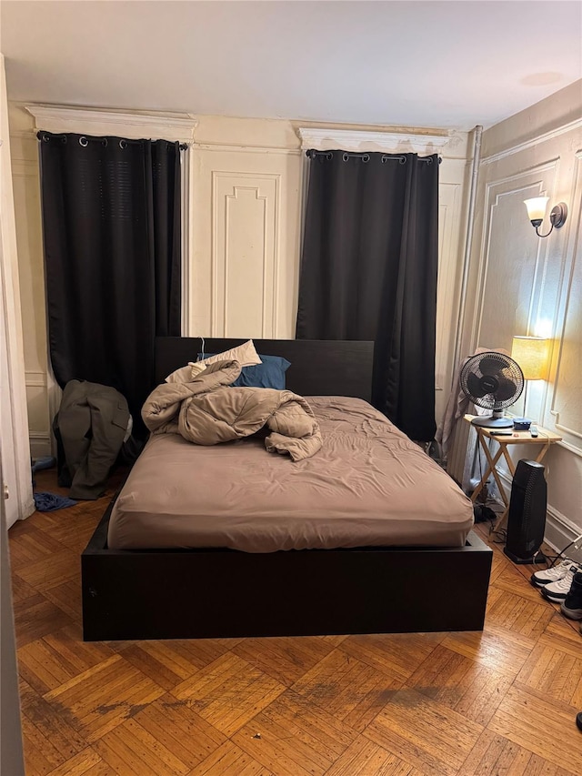 bedroom featuring parquet flooring