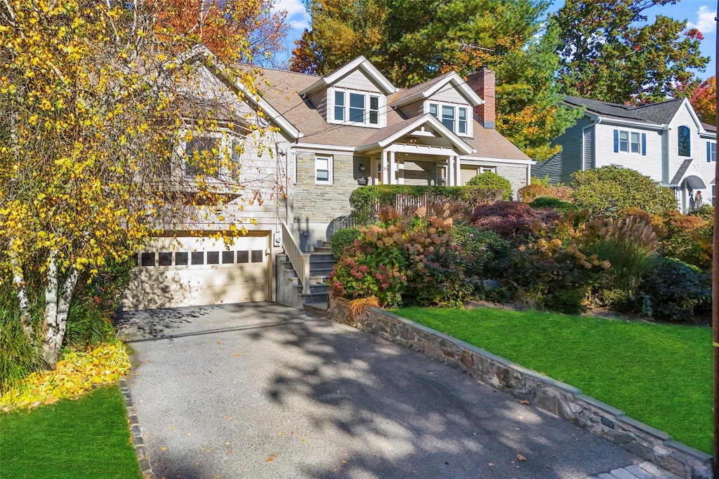 view of front of property with a front yard and a garage