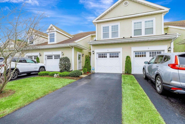 view of front facade featuring a front lawn and a garage