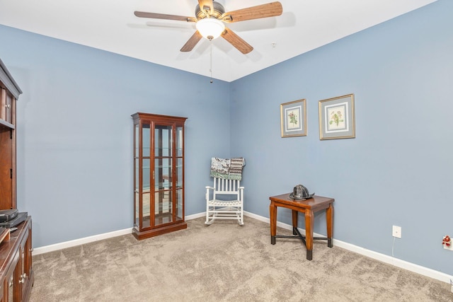 living area featuring ceiling fan and light colored carpet