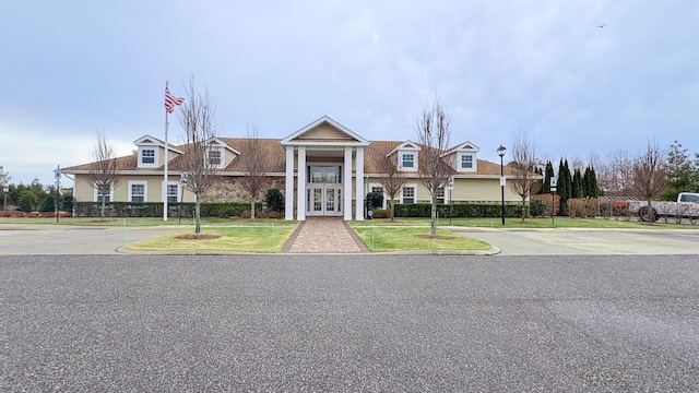 view of front of property with a front lawn and french doors