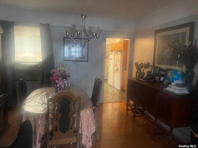 dining room featuring wood-type flooring and a chandelier