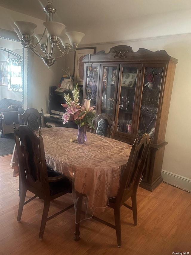 dining space featuring a chandelier and wood-type flooring