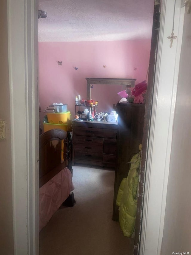 bedroom featuring carpet and a textured ceiling