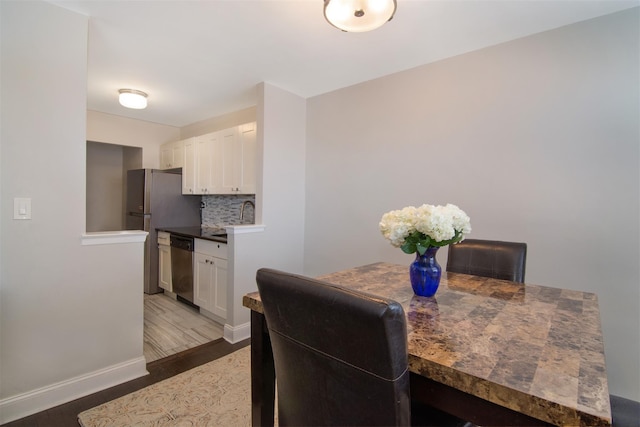 dining area with sink and dark hardwood / wood-style floors