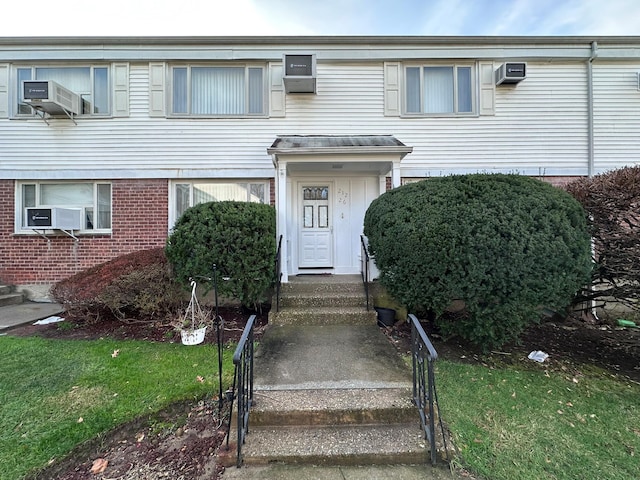 view of property featuring an AC wall unit and cooling unit