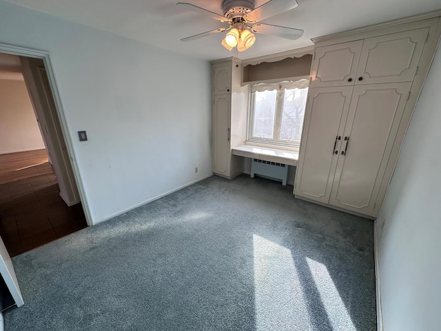 unfurnished bedroom featuring radiator heating unit, a closet, light colored carpet, and ceiling fan