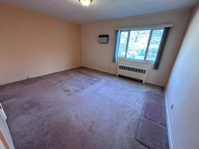 carpeted spare room featuring a wall mounted air conditioner and radiator