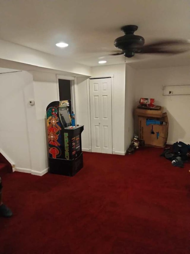 misc room with carpet and ceiling fan