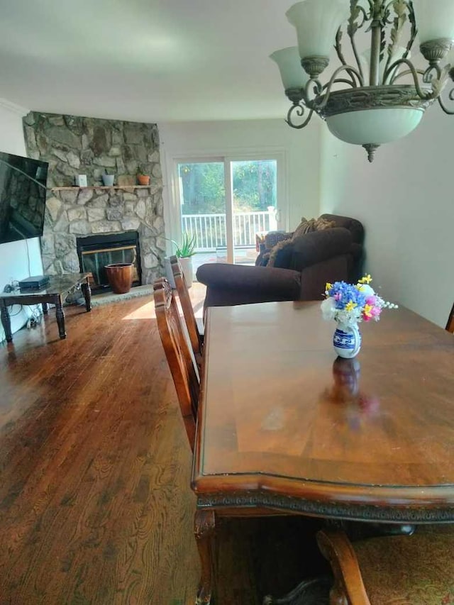 dining area with dark hardwood / wood-style flooring and a fireplace