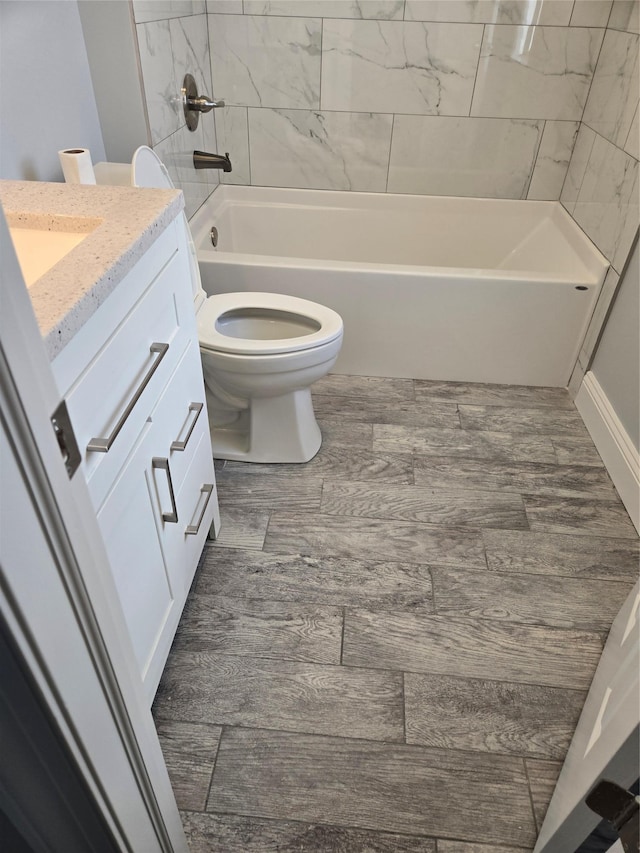 full bathroom with vanity, toilet, and tiled shower / bath combo