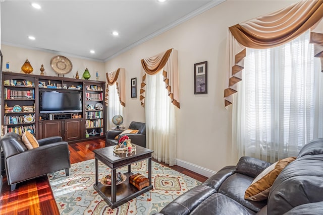 living room featuring wood-type flooring and crown molding