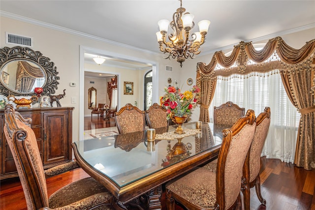 dining room featuring a chandelier, crown molding, and dark wood-type flooring