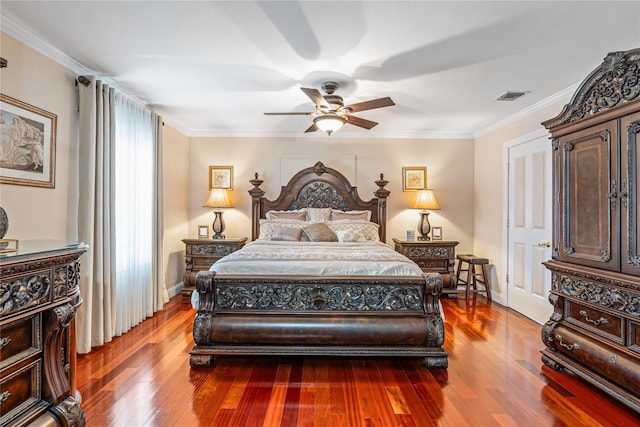 bedroom featuring hardwood / wood-style floors, ceiling fan, and ornamental molding