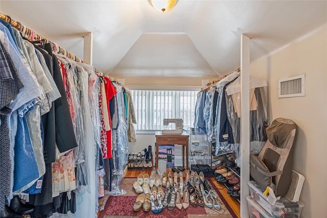 spacious closet featuring hardwood / wood-style flooring and lofted ceiling