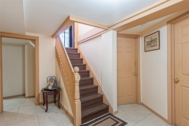 stairway featuring tile patterned floors