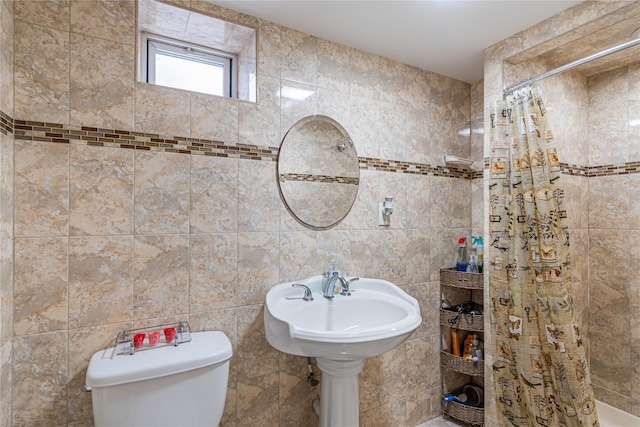 bathroom with toilet, walk in shower, and tile walls