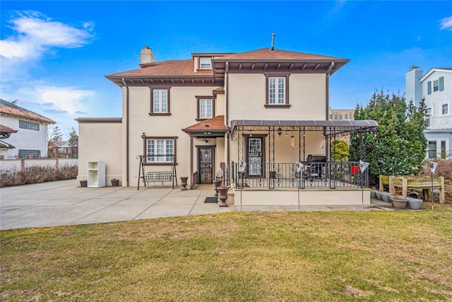 rear view of property with a lawn