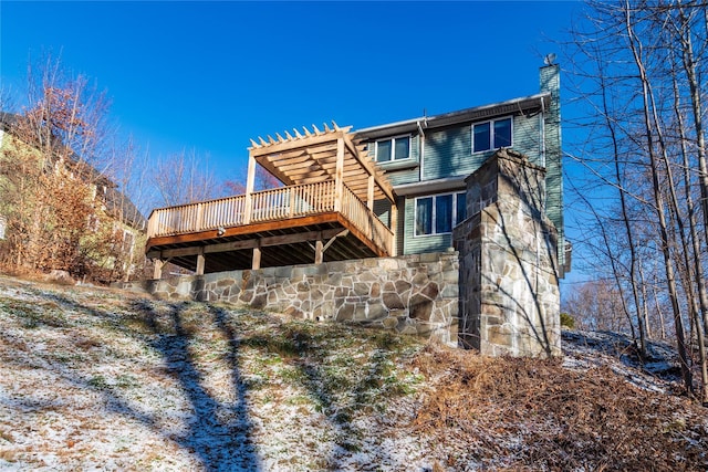 back of house with a wooden deck