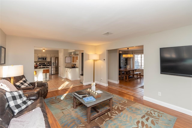 living room with light hardwood / wood-style flooring