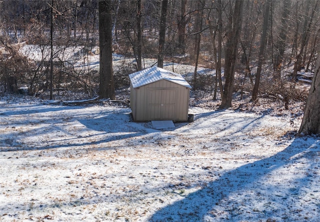 yard layered in snow with a shed