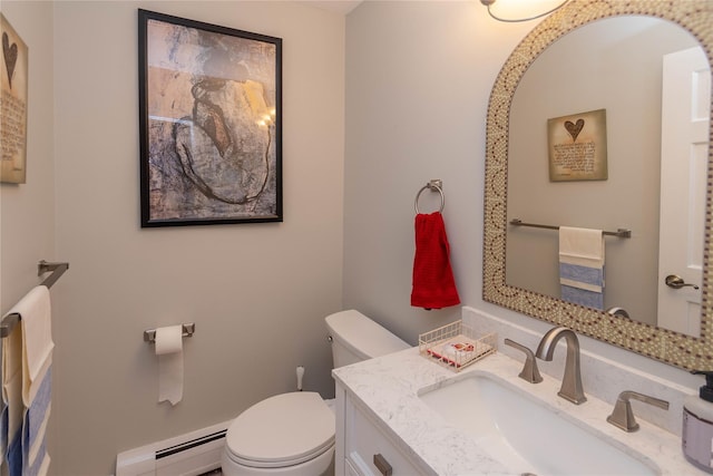 bathroom with vanity, toilet, and baseboard heating