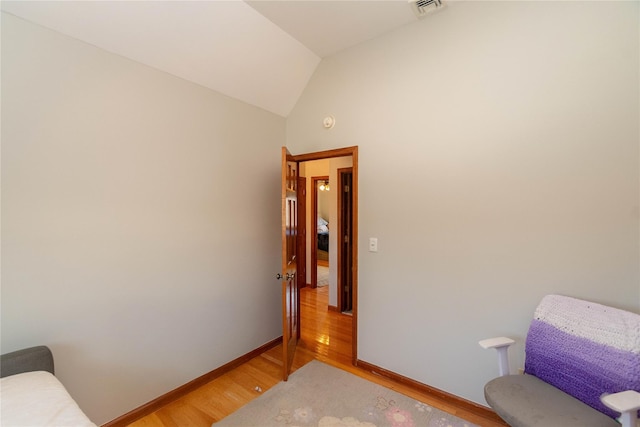 living area featuring hardwood / wood-style flooring and lofted ceiling