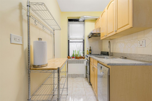 kitchen with light brown cabinetry, stainless steel dishwasher, radiator, sink, and light tile patterned floors