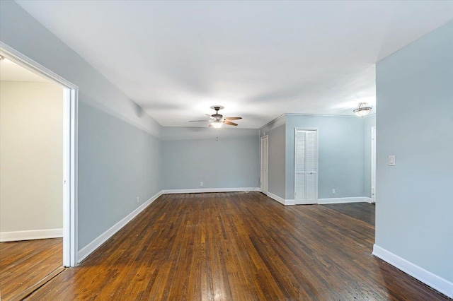 unfurnished room featuring ceiling fan and dark hardwood / wood-style flooring